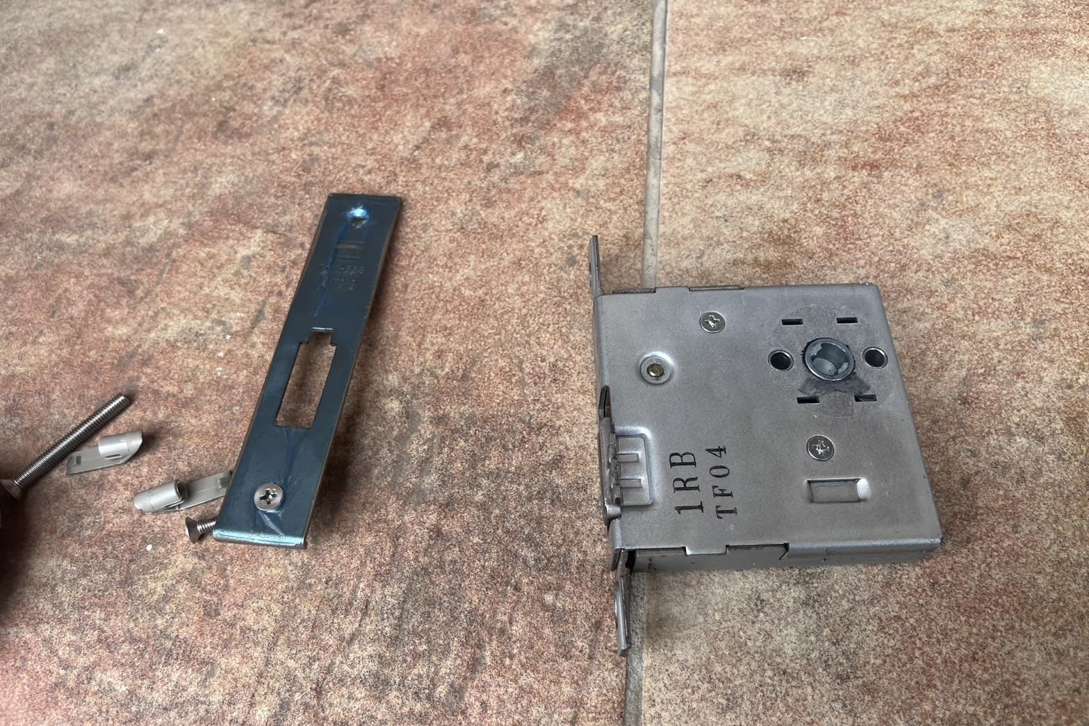 修理中の玄関の鍵（錠ケース内の汚れ）（錠ケース洗浄）